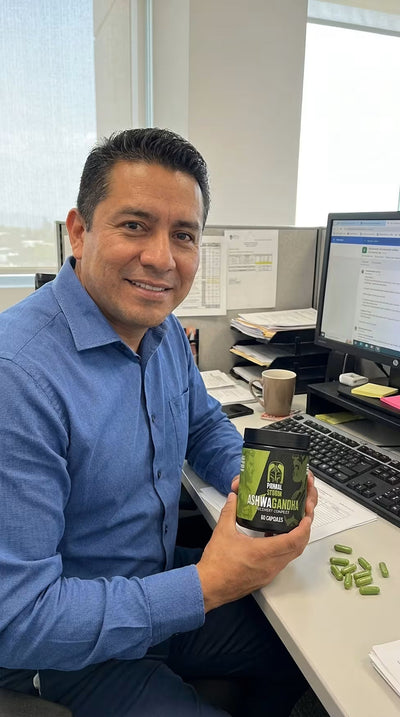Customer holding Primal Storm Ashwagandha at his desk