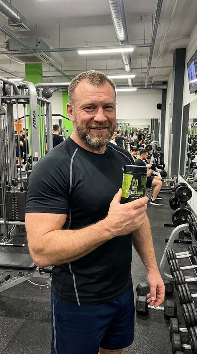 Customer holding Primal Storm Ashwagandha in the gym